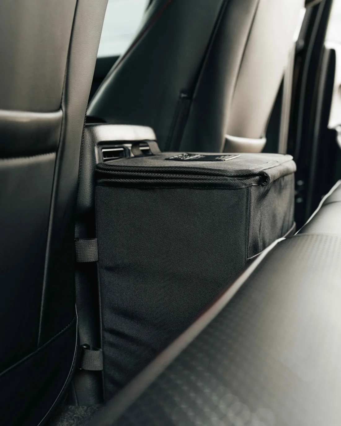 Side view of the black Double Deez Goodz car garbage can mounted behind the center console.