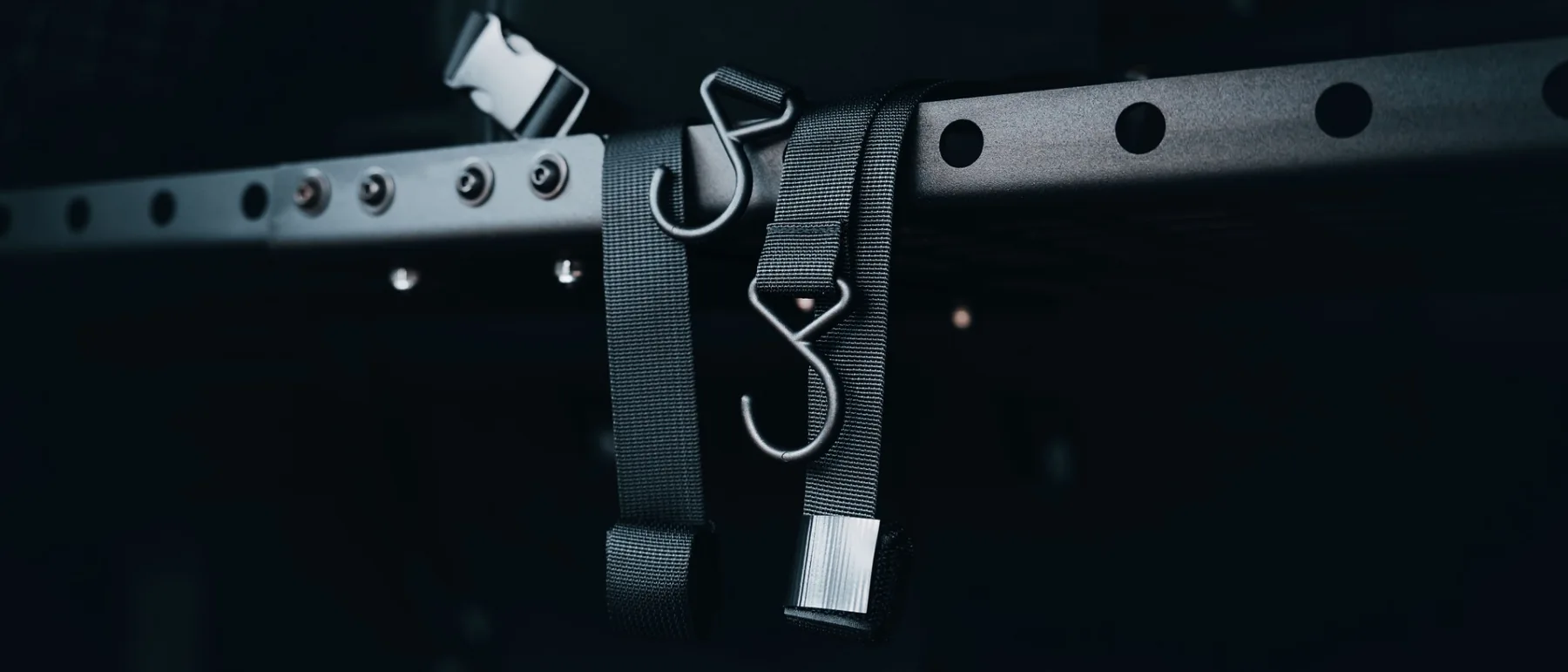 Close-up of black mounting straps and metal hooks used to hang the Double Deez Goodz car trash can.